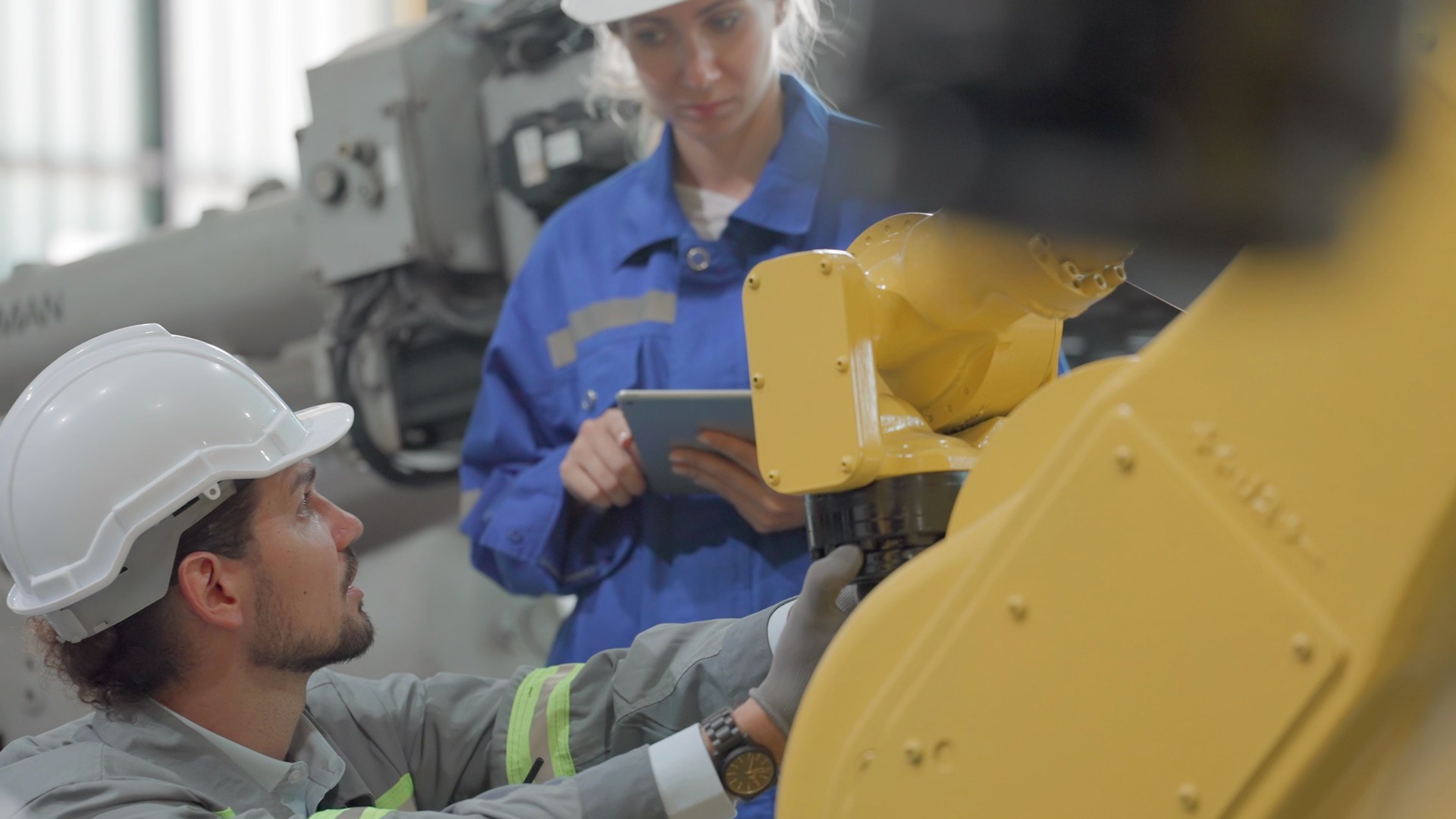 Maintenance engineering and technician have experience and expertise engineering, repairing or maintenance robotic arm according to program for automated production in factory. Worker wearing safety uniform working on manufacturing plant in heavy industry